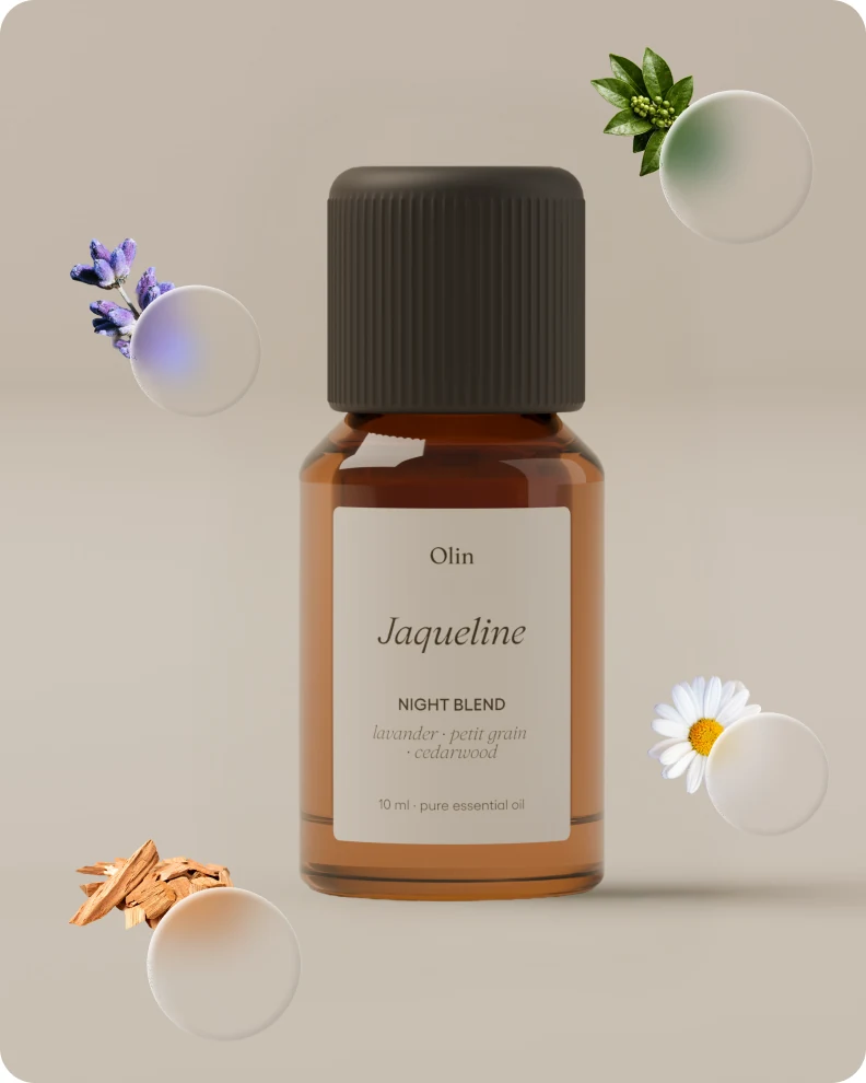 Jacqueline evening blend bottle surrounded by its ingredients: lavender, petitgrain, chamomile and cedarwood